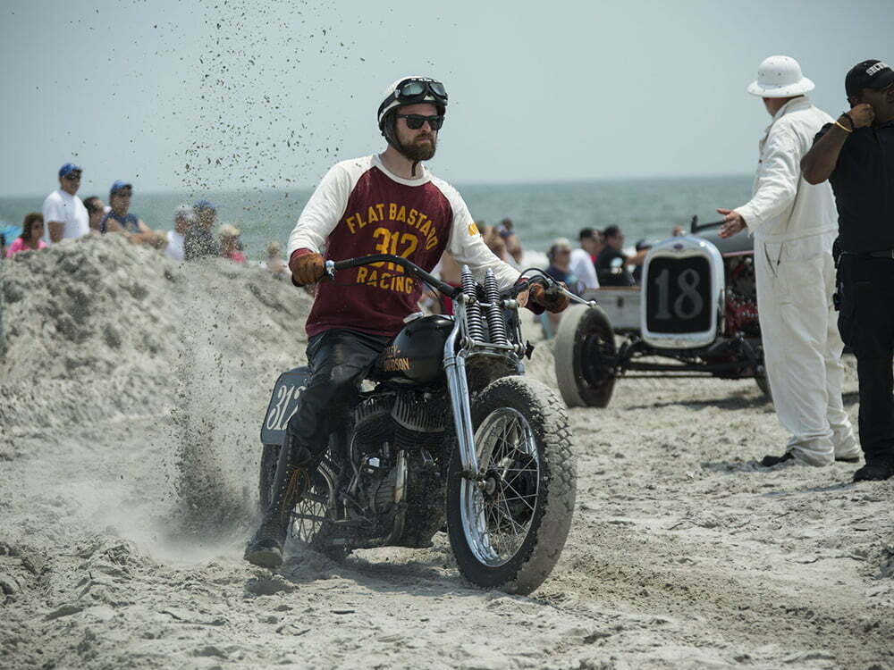 motorcycle kicking up sand