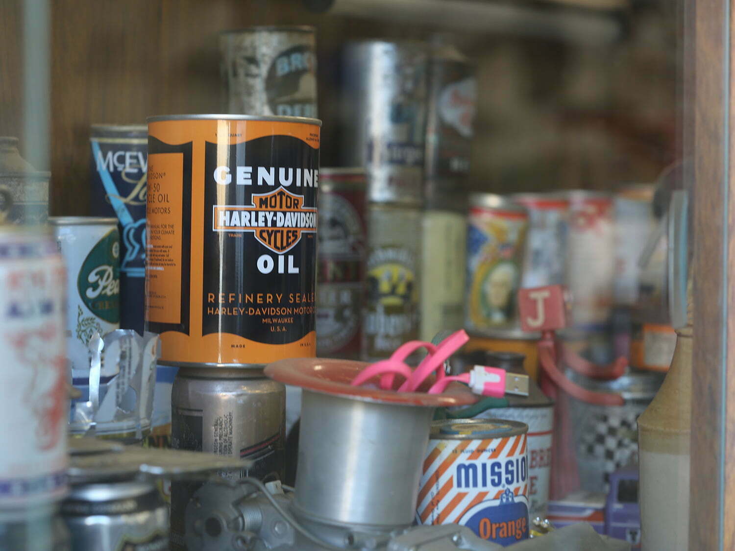 Old oil and beer cans in a display case