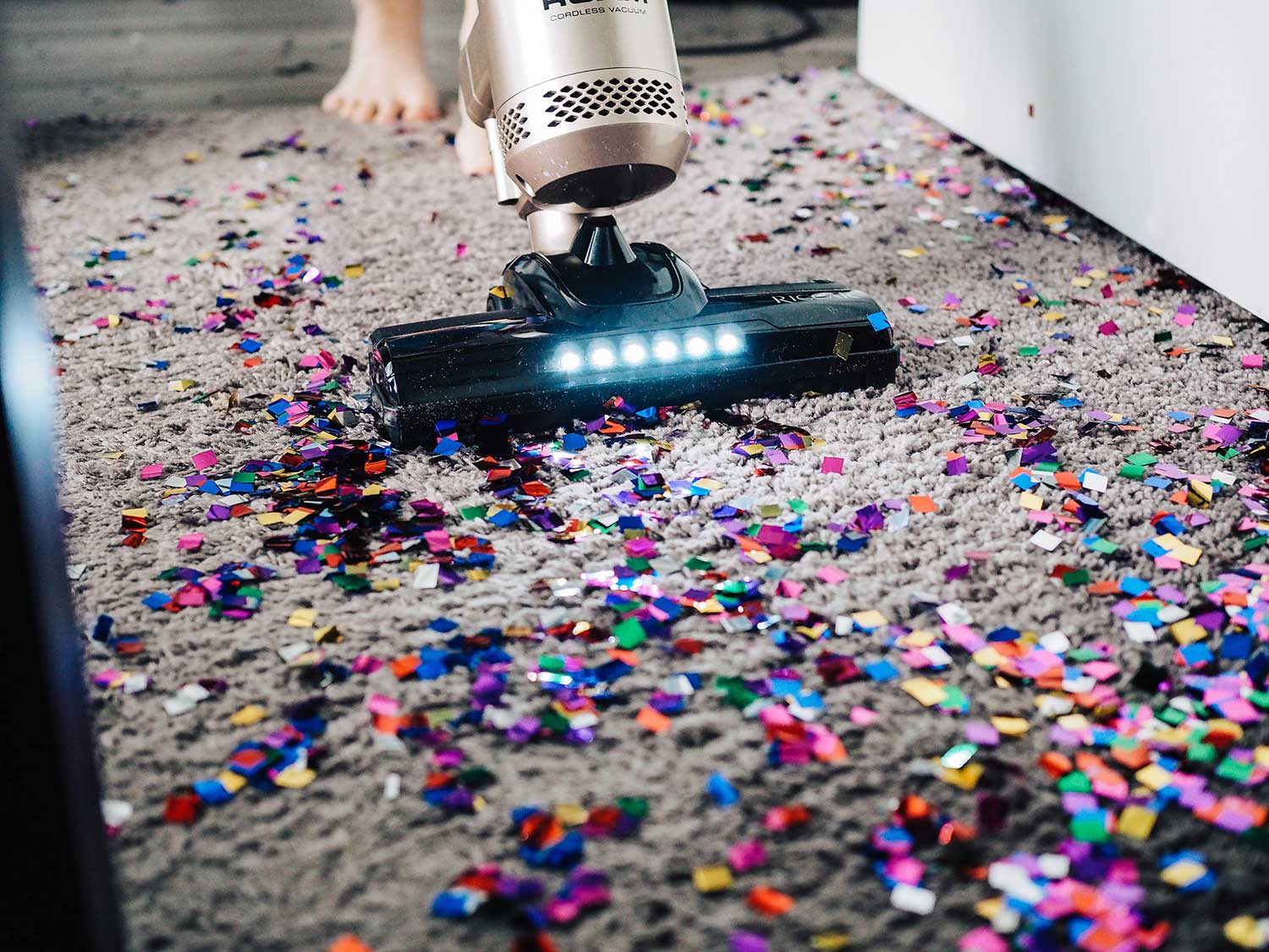 Vacuuming confetti covered floor.