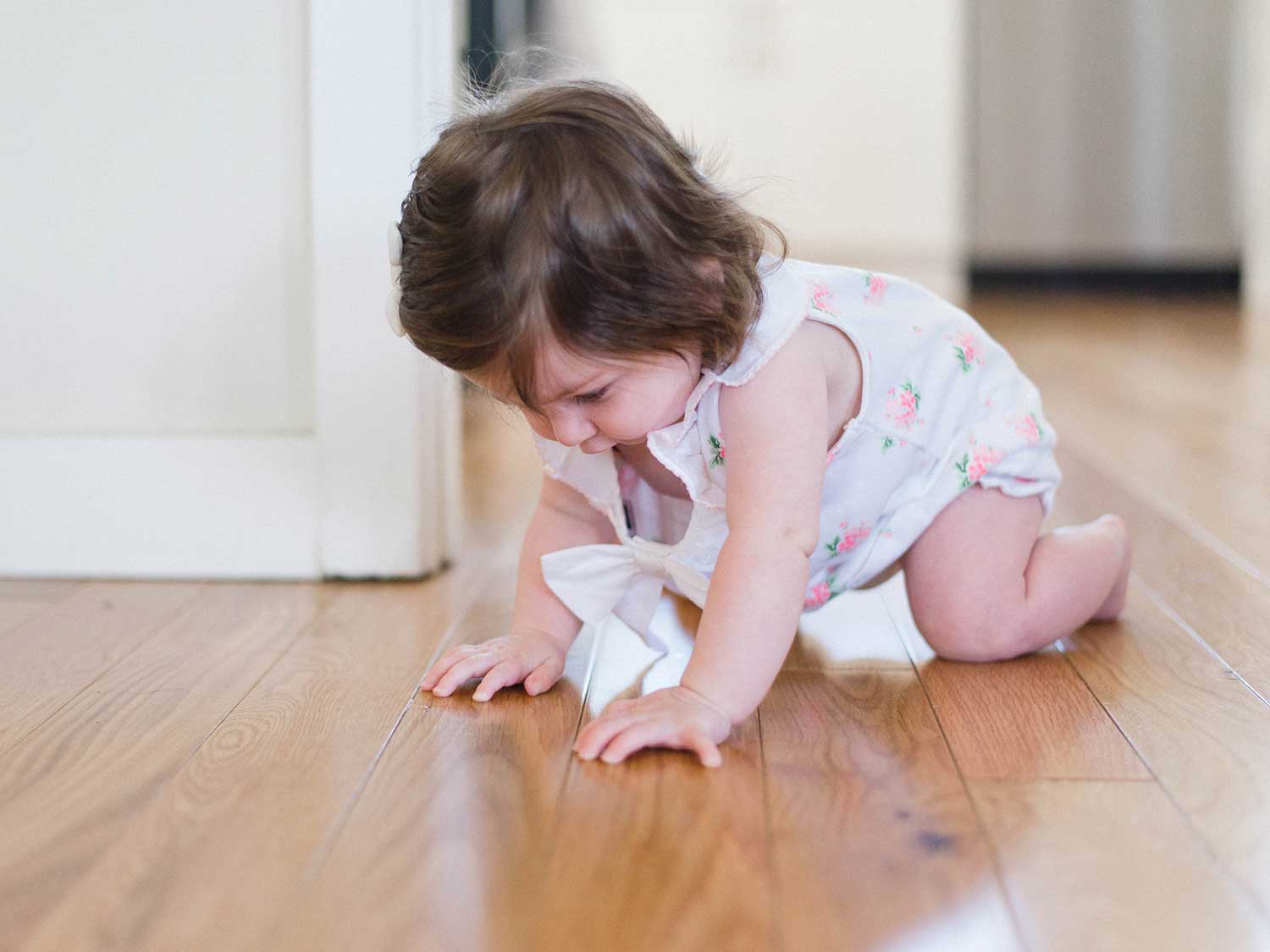 Baby crawling on the floor.