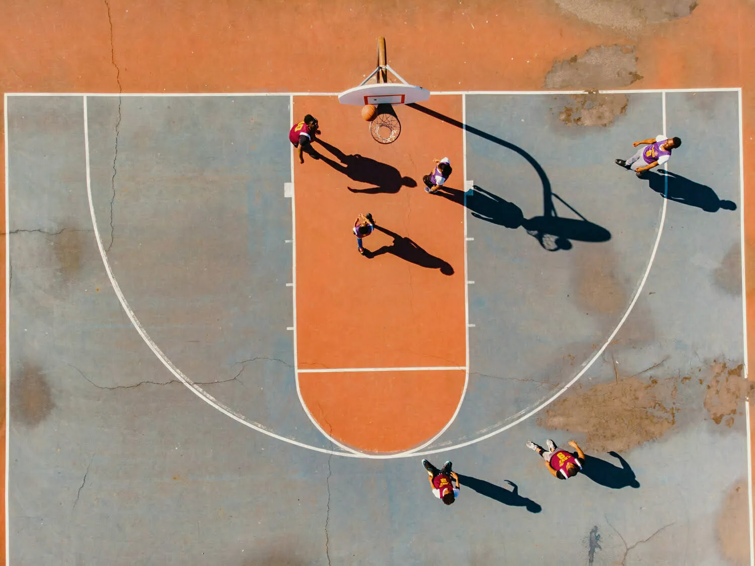 A team plays basketball on basketball court.