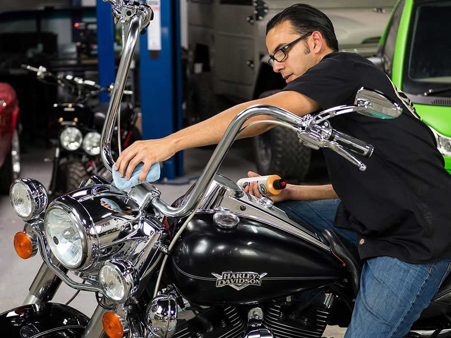 Washing motorcycle with cleaning sponge