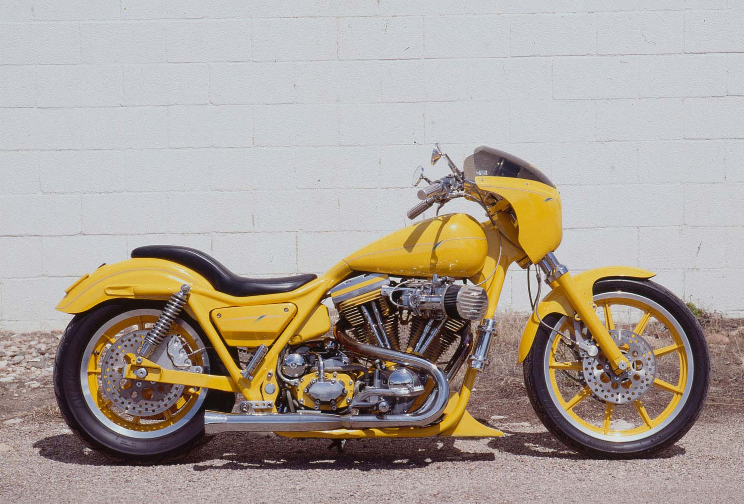 The gas tank and frame were modified to flow together so cleanly on Gene Koch’s “Hamster Yellow” FXRH.