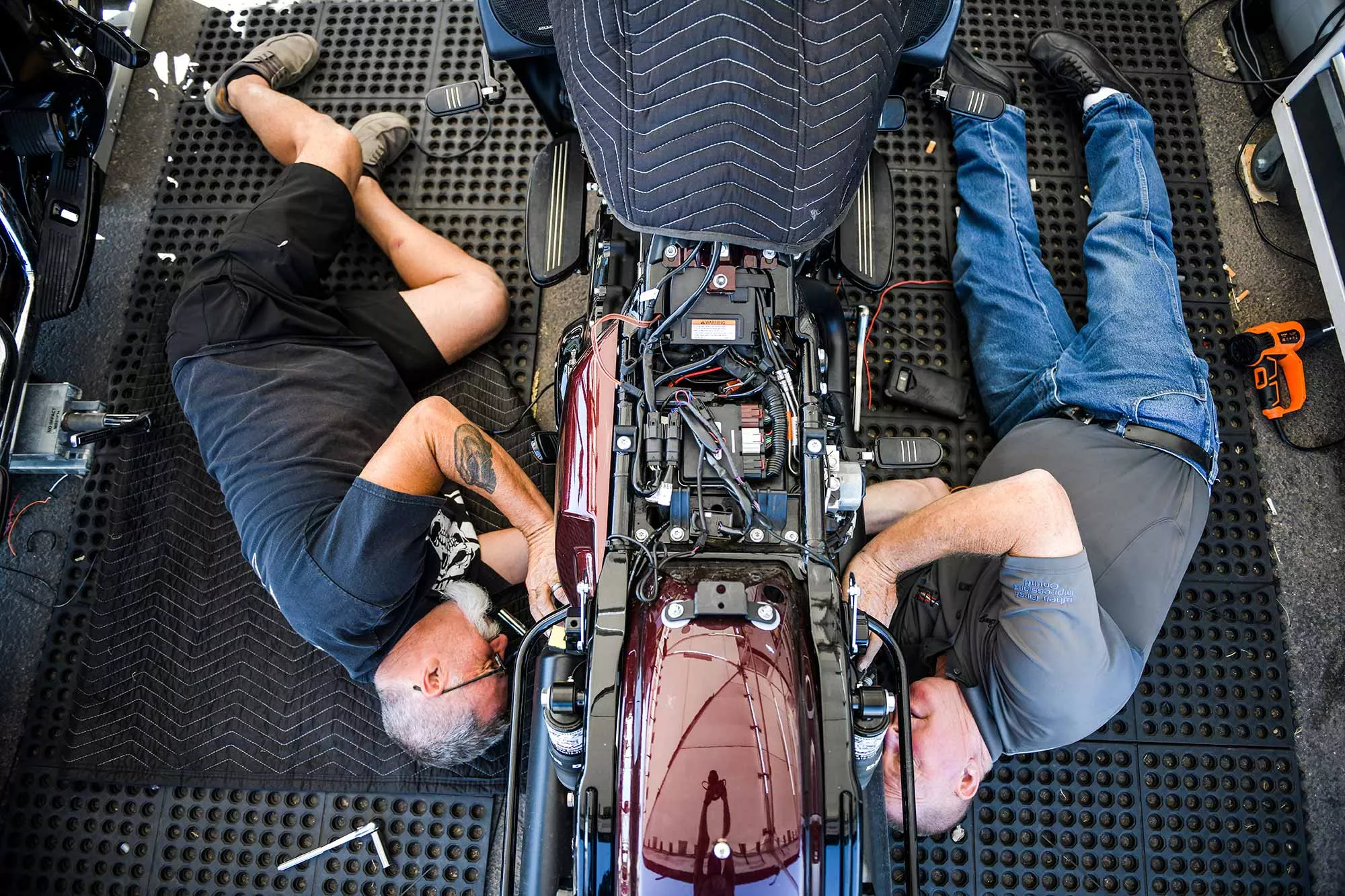 All 'Bout Customs owner Joey Arceneaux, left, and mechanic Doug Perez work on a motorcycle at the Buffalo Chip during the 80th Annual Sturgis Motorcycle Rally in Sturgis.