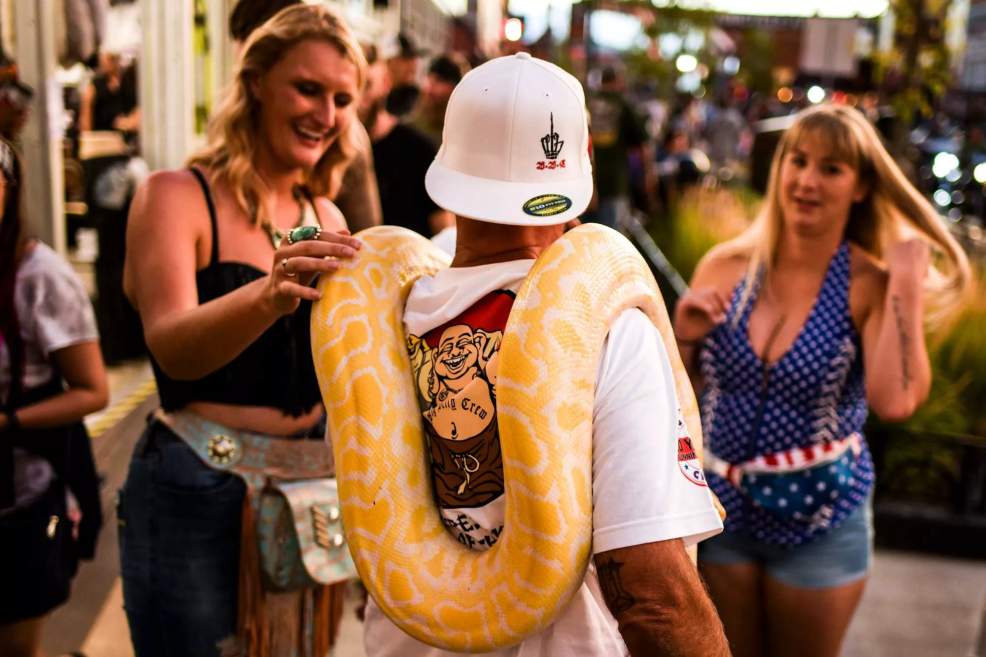 Yellow snake around man's neck at Sturgis motorcycle rally
