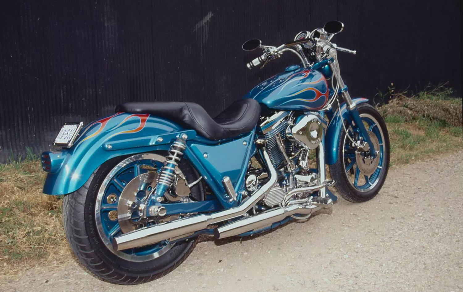 Teal pearl overlaid with persimmon-to-goldenrod flames dress up this 1987 Harley-Davidson FXR SP.
