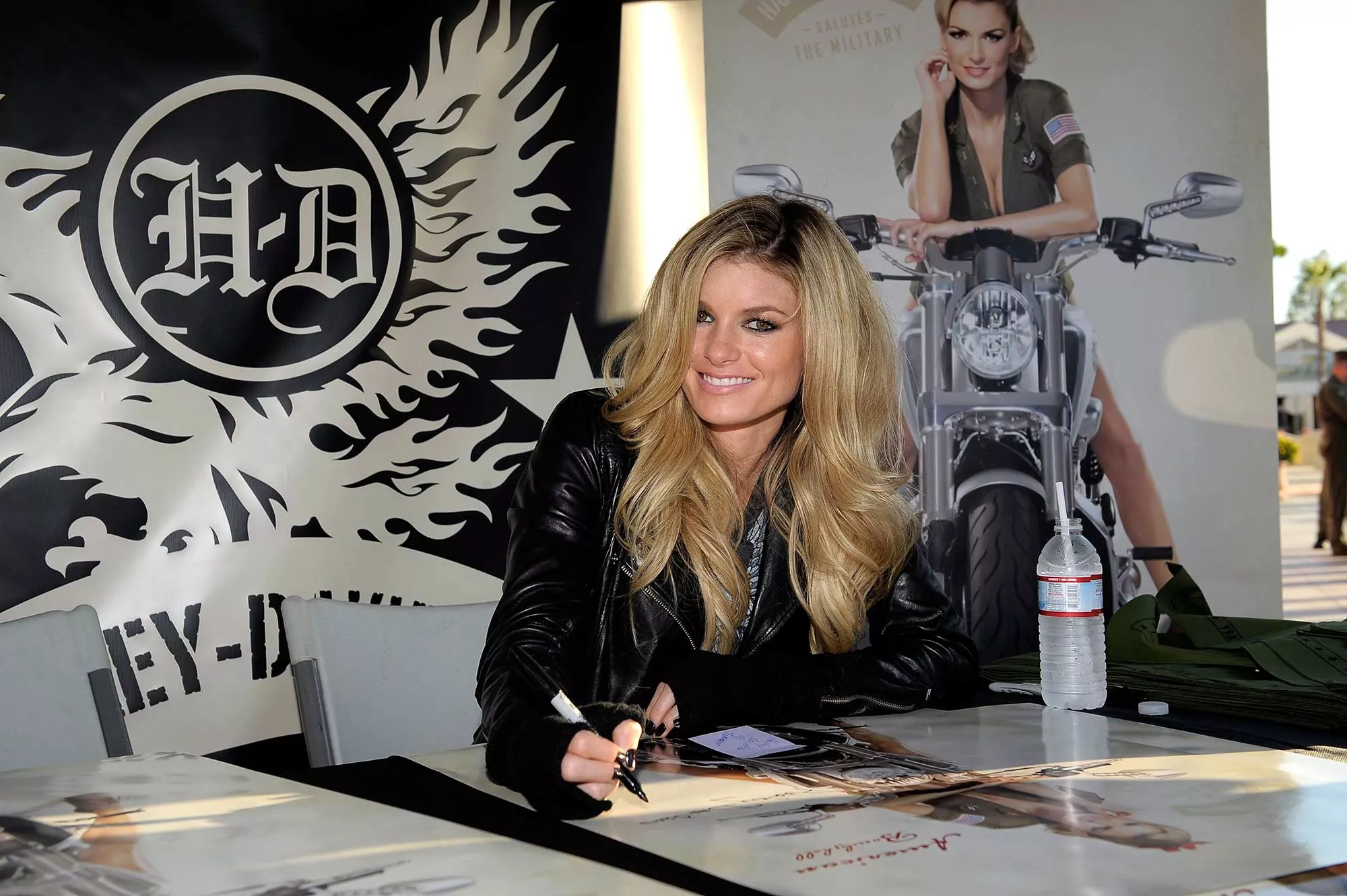 Model and motorcycle rider Marisa Miller signed autographs for Marines at a Harley event.