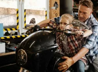 Careful great dad making sure his daughter sitting safe